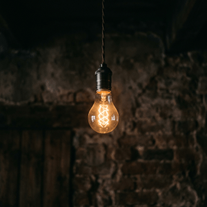 Glowing vintage Edison bulb suspended by a twisted cord